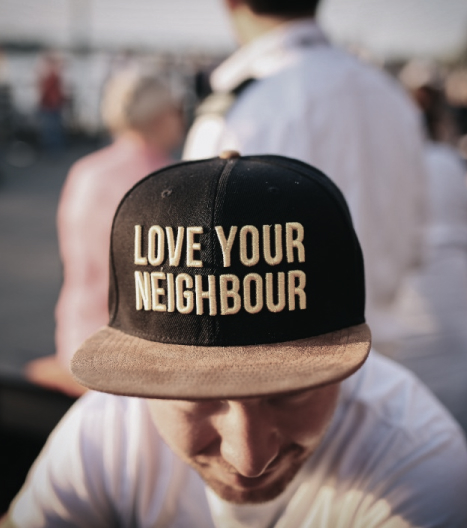 Man wearing a hat saying love your neighbor